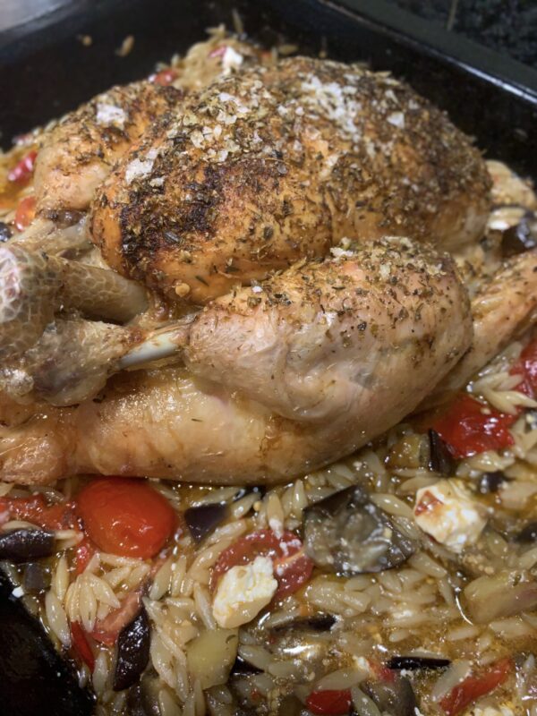 Herb roasted chicken with aubergine, orzo, feta and tomatoes