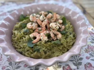 Baked courgette orzo topped with garlic and chilli prawns and fresh basil. Baked courgette orzo topped with garlic and chilli prawns and fresh basil.